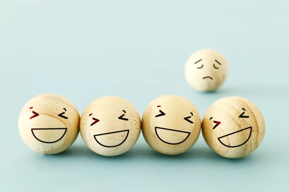 Sad Face Behind Smiling Faces Representing Social Anxiety Stigma